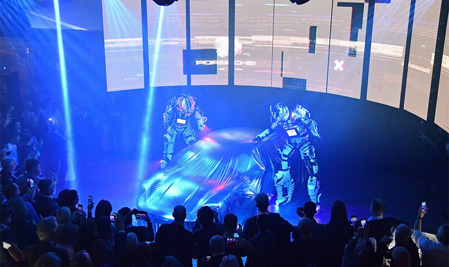 2 robots géants dévoilent le nouveau Porsche Taycan
